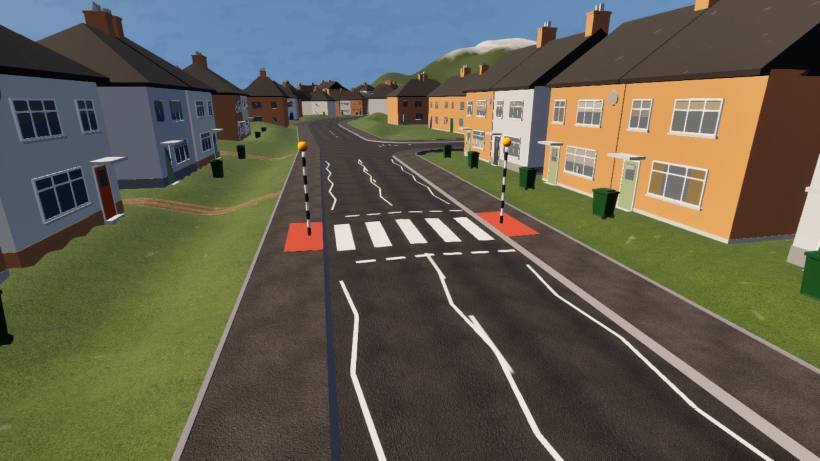A road through an estate of semi-detached houses in grey, cream and orange render, wheelie bins on the verges. A zebra crossing of white stripes spans the road, with a black and white pole topped by an orange globe at each kerb, red textured paving at their feet and white zig-zag lines either side.