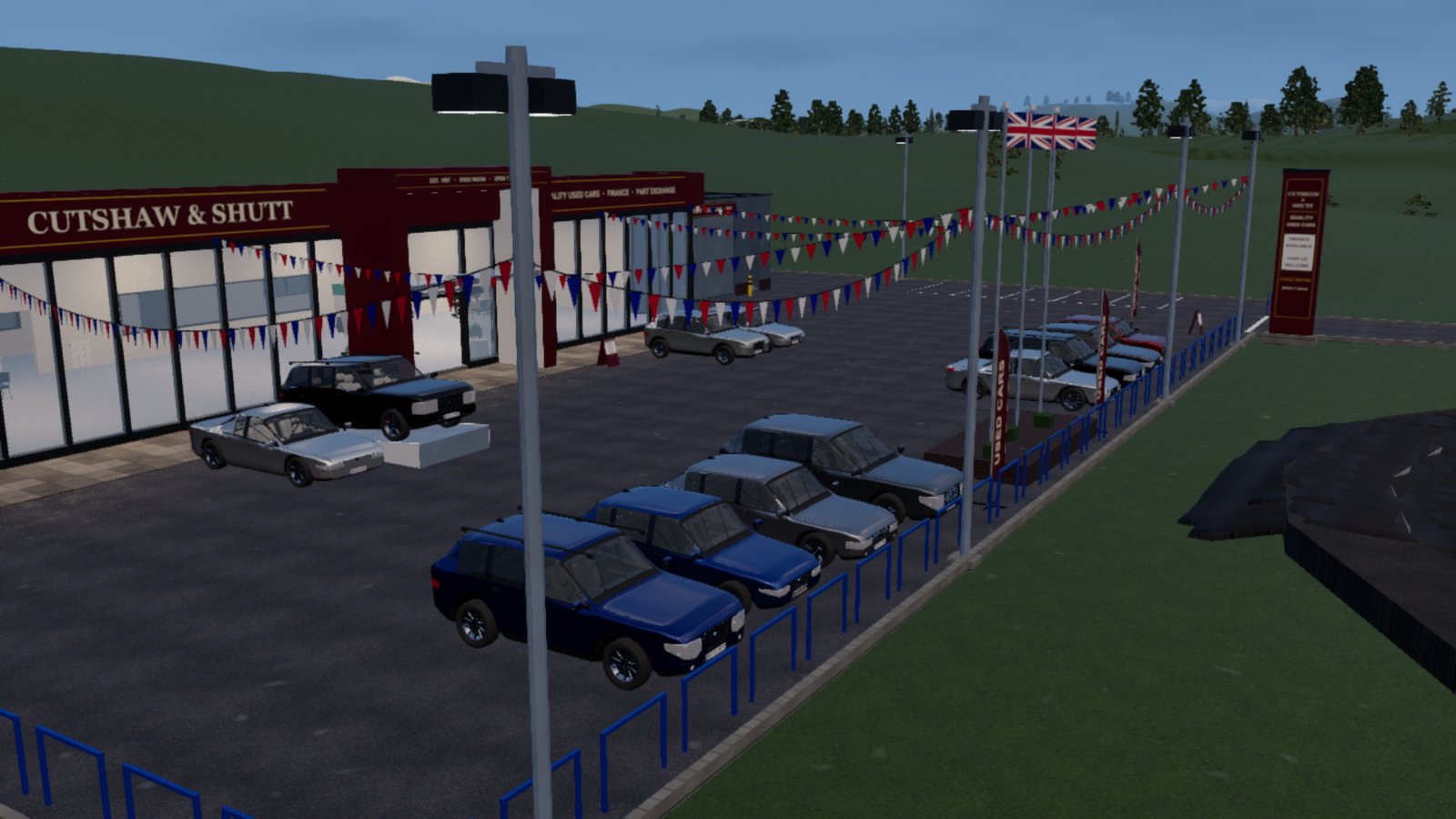 A used-car dealership at dusk: a long glass showroom with a claret fascia reading CUTSHAW & SHUTT, a tarmac forecourt of about a dozen parked cars in blues, greys, black and silver, red, white and blue bunting strung between tall lamp posts, three Union flags on poles, USED CARS feather banners and a blue railing along the grass edge. A tall claret totem sign stands at the far end.