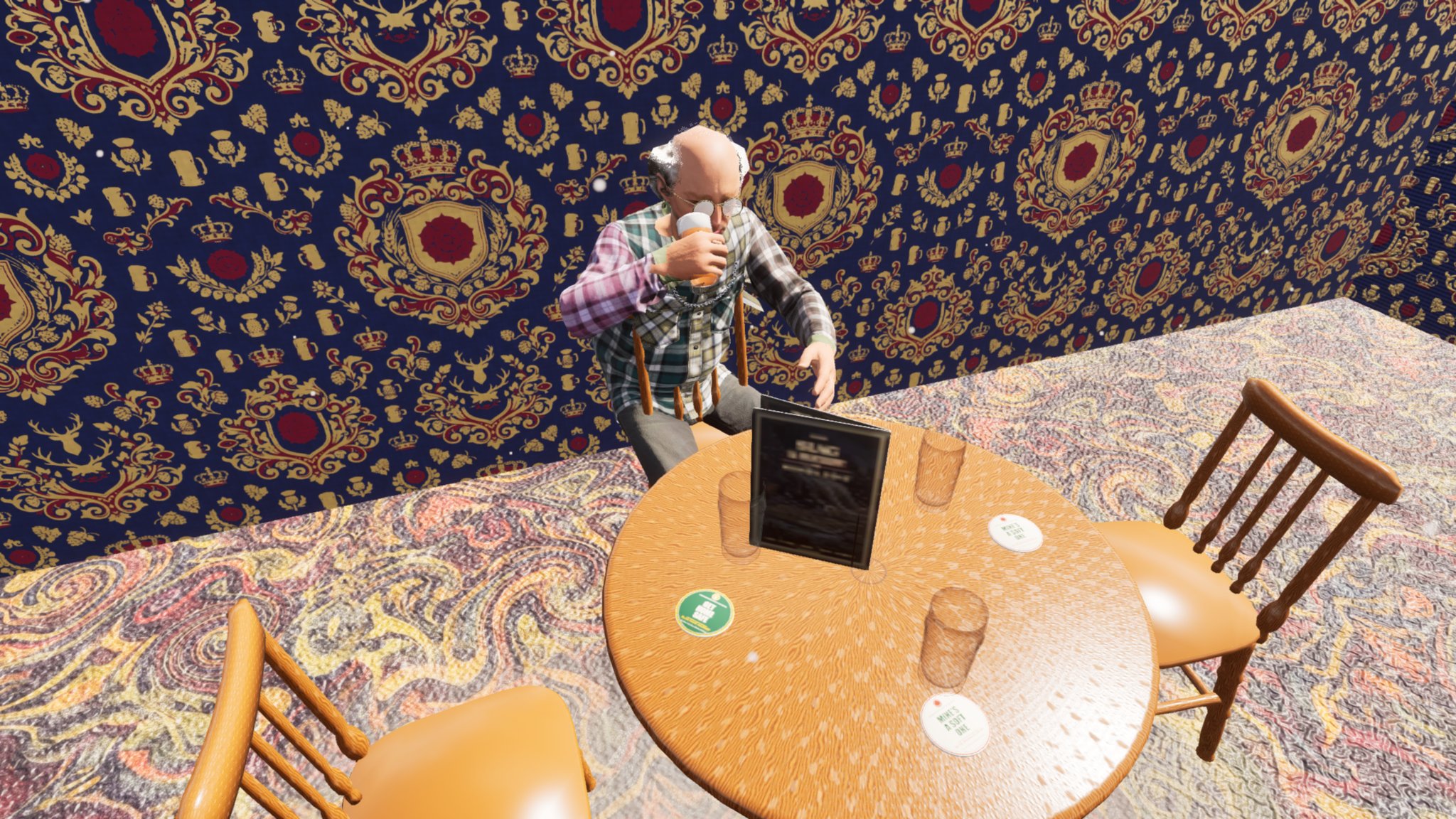 A high view into a pub corner with patterned blue and gold wallpaper. An older bald man in a plaid shirt sits on a wooden chair at a round table and raises an upright pint glass to his mouth. Beer mats and a menu stand on the table.
