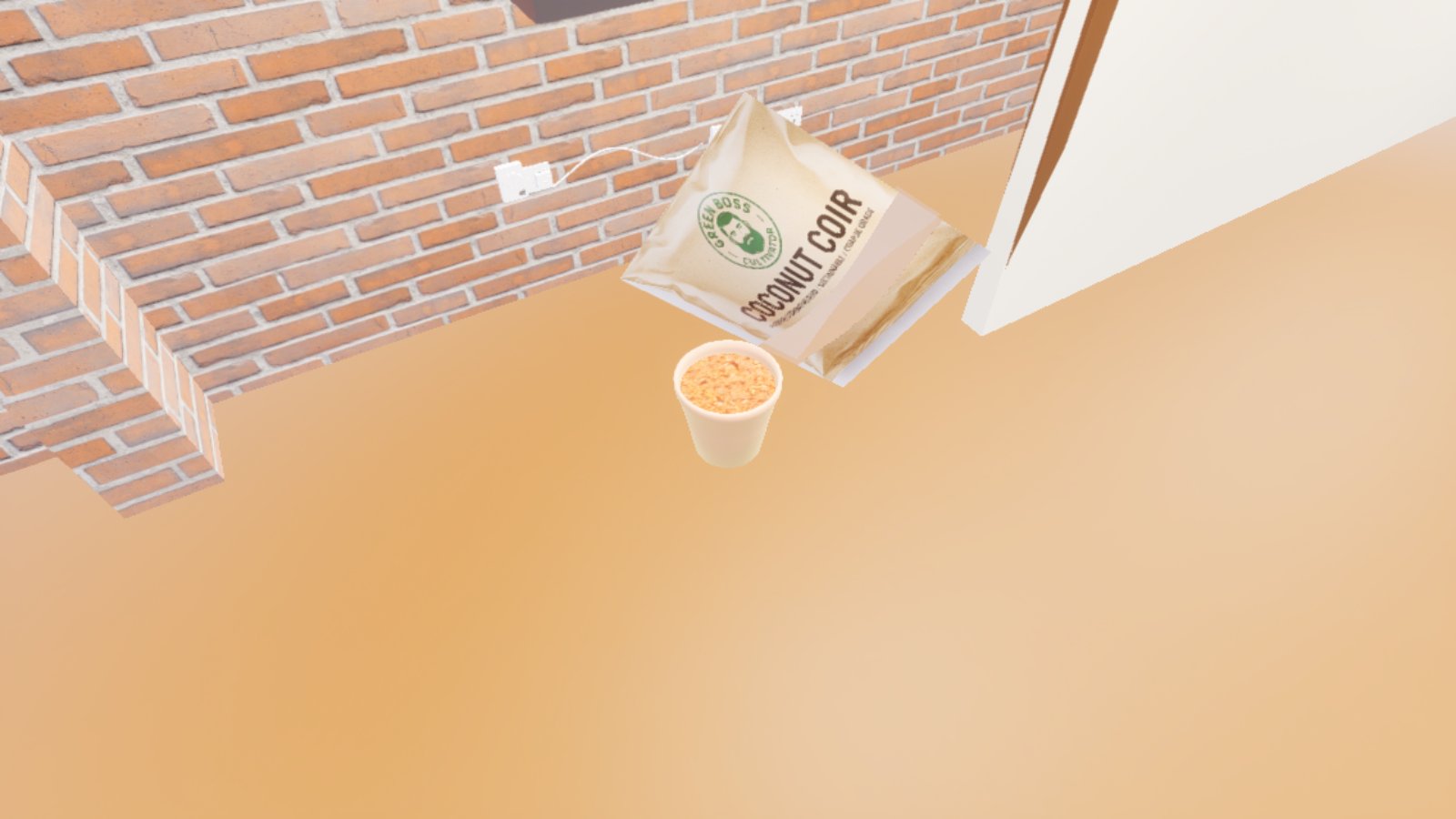 The same cellar corner. The cream pot is now filled to the rim with loose brown coir, and the printed coir bag, crumpled and empty, is lifting away above it on the right. A wall socket with a white cable is on the brick behind.