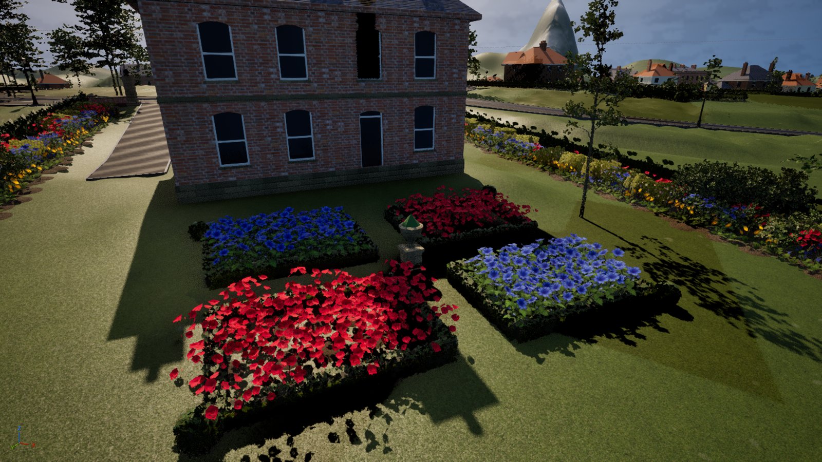 Looking down on the back of a brick villa in low sun: four rectangular beds edged with clipped box hedge, two of red roses and two of blue flowers, set in quarters round a stone urn on a grass cross, with long mixed borders and a young tree beyond.