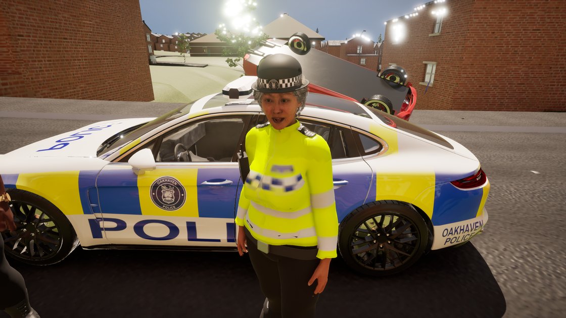 A police officer in a hi-vis jacket mid-sentence on the pavement beside a liveried Oakhaven Police car.