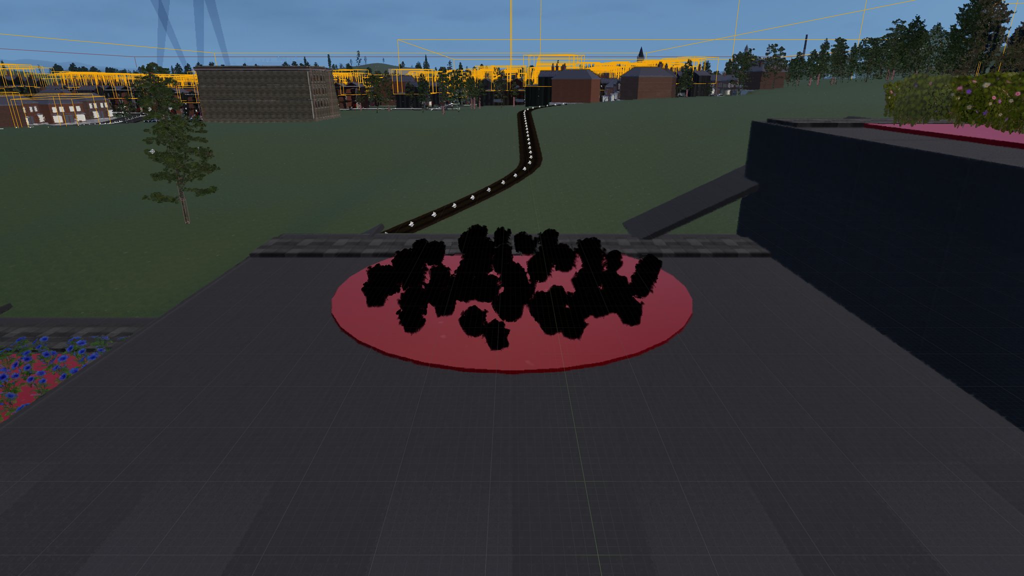 A ring of rose bushes rendered as solid black silhouettes on a bright red placeholder disc, on a paved terrace beside a bed of blue flowers, with a curving gravel path and a distant terraced town visible behind yellow debug wireframe boxes.