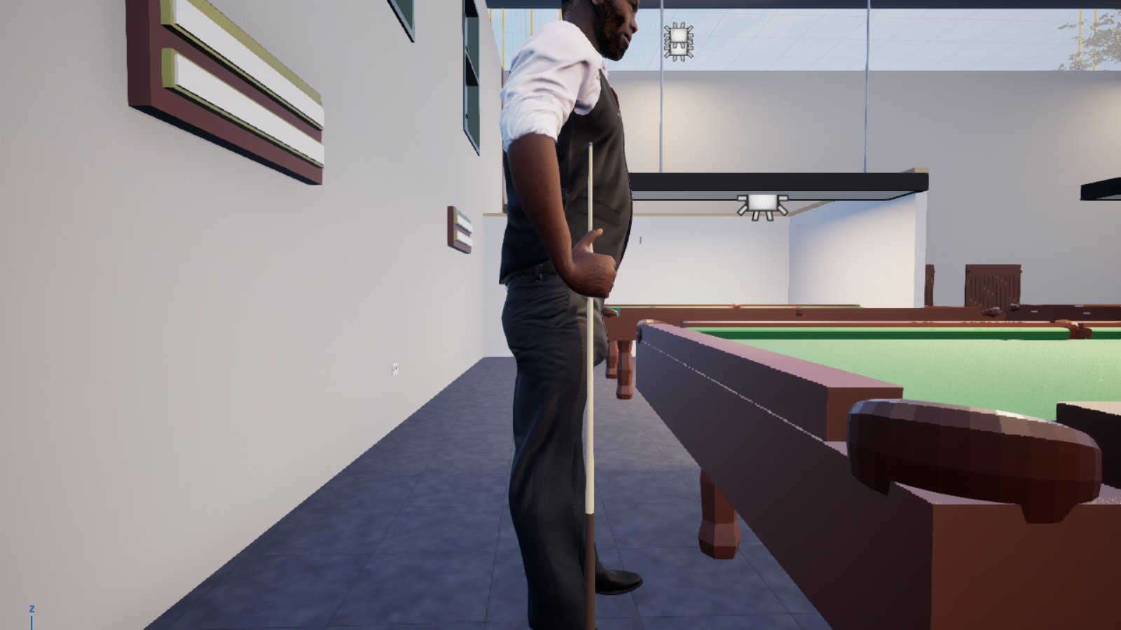 A close side view of the same waistcoated man standing beside a snooker table, seen from his left. His right hand is closed round the cue at hip height with the thumb up and the knuckles near vertical, and the butt of the cue rests on the floor beside his shoe. Behind him are a papered wall, framed pictures and the shaded lights over the further tables.