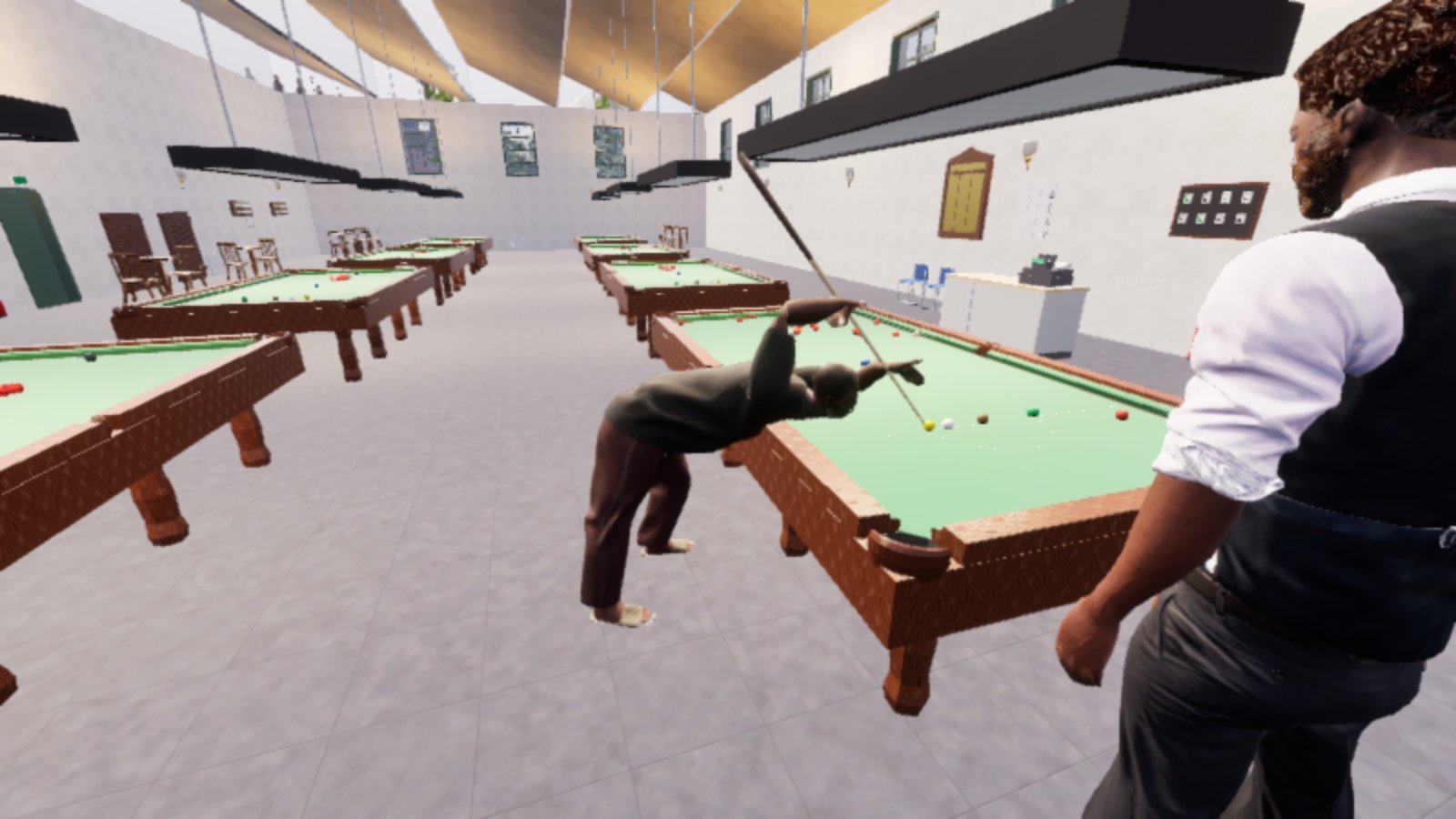 A man in a dark top and trousers is down on a snooker shot, bent over the table with the cue running along his eyeline towards the white, in a bright hall with four full-size tables under shaded lights. A second man in a waistcoat and white shirt stands watching in the right foreground, seen from behind. The striker's feet read as pale untextured blocks.