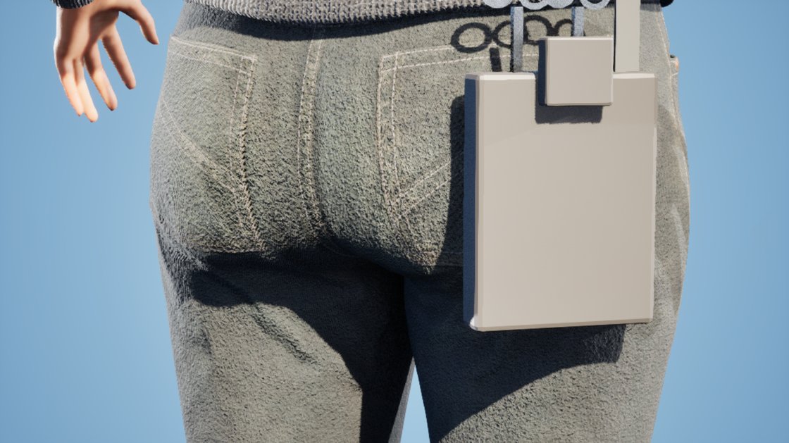A close rear view of a woman's hip in grey jeans, with a plain beige pouch hanging from her waistband on the right side, sitting just outside the denim.