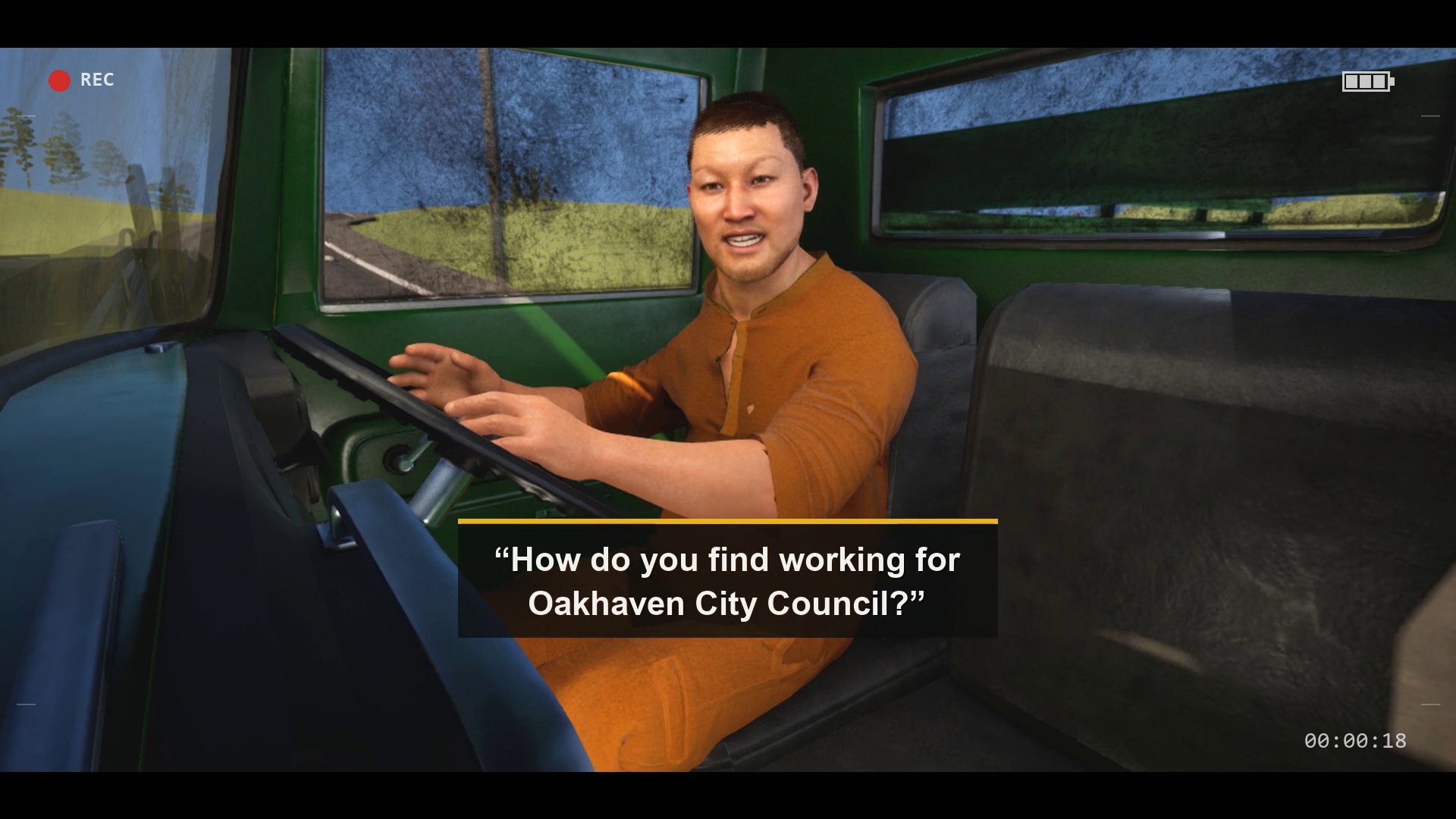 A frame of the induction film: a young man in orange council overalls at the wheel of a green cab, captioned: How do you find working for Oakhaven City Council?