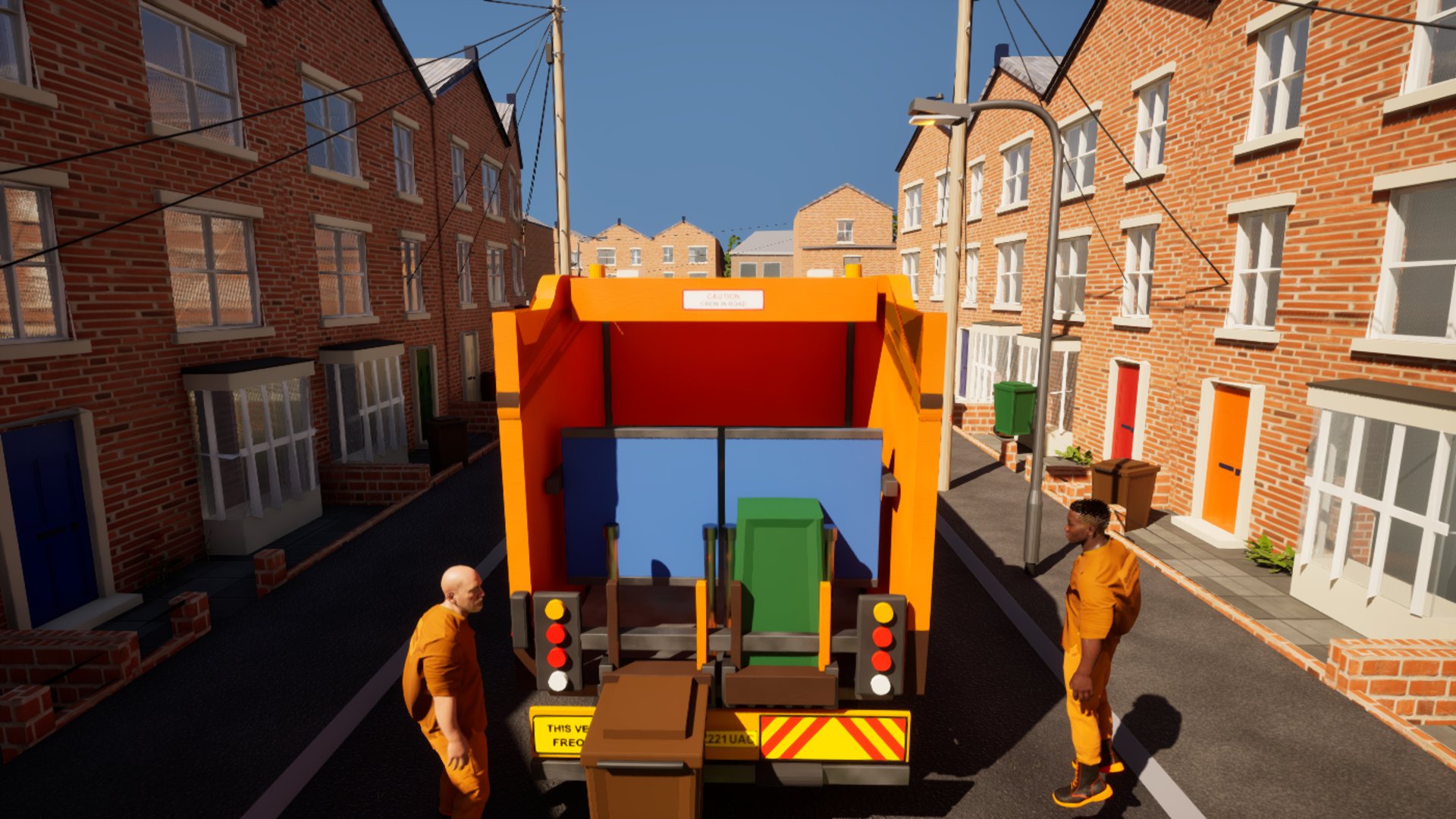 From a drone behind the lorry: two loaders in orange hi-vis stand either side of the tailgate with a green bin on the lift, the terrace running away ahead.