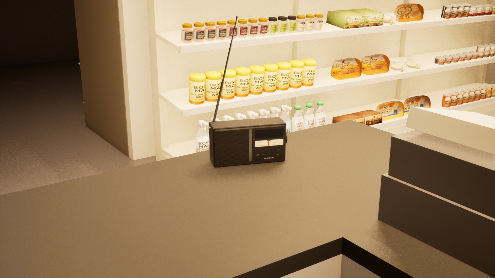 A small radio with its aerial up on a shop counter, shelves of own-brand jars, bread and cleaning products behind it.