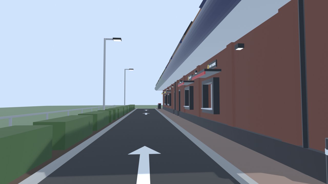 The drive-thru lane down the back of the building: a strip of tarmac with a white arrow, a hedge on the left and the brick back wall with its serving hatches on the right.