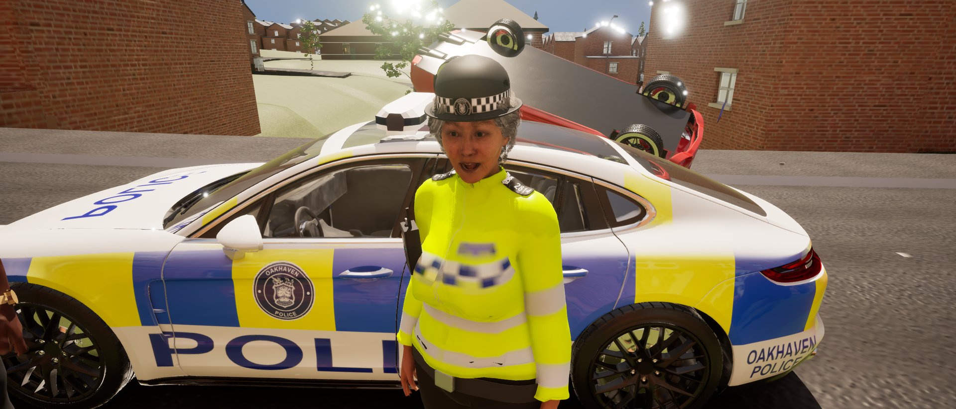 An officer on the pavement beside a liveried Oakhaven Police car.